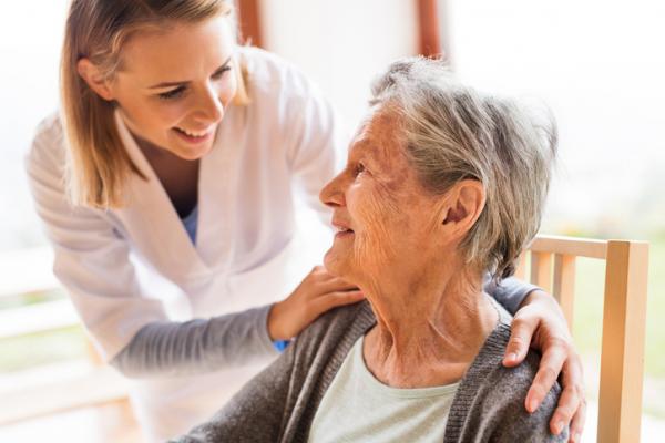 Cuidadora de una residencia de mayores con una anciana